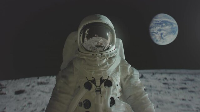 Apollo 11 astronaut on the moon surface with earth in the background. 