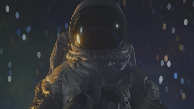Astronaut in space suit close up with stars in the background.