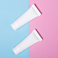 Cream tube mock up isolated on pink and blue background set of two white blank cream jars