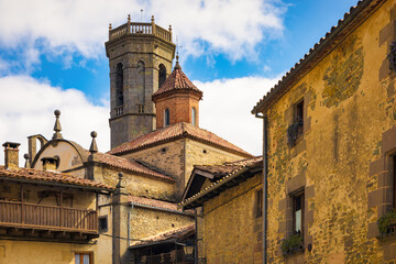 Fototapeta na wymiar View of the bell tower and the dome of the Saint Miquel church of the medieval nucleus of the town of Rupit, Catalonia, Spain