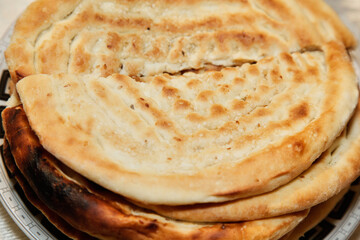 Pita bread sprinkled with sesame seeds. Detail photo. Other breads are underneath. Delicious, you get hungry right away. 
