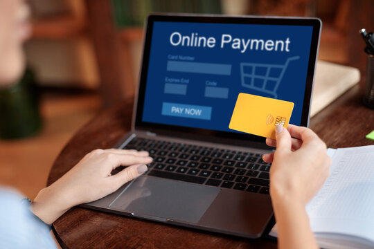 Woman using laptop and credit card, online payment concept