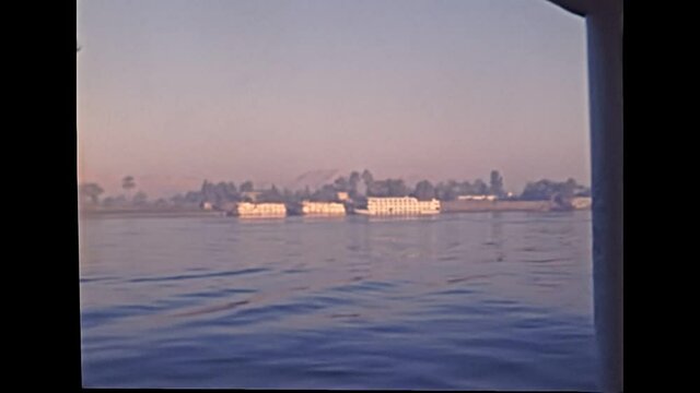 Touristic tour in Luxor city by boat on Nile river. Historical archival of Egypt in 1980s with tourists. Historical archival of Egypt in 1987.