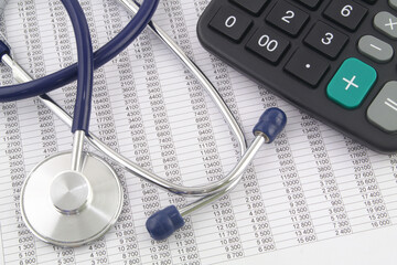 Price of medicine and insurance concept, stethoscope and calculator on financial reports