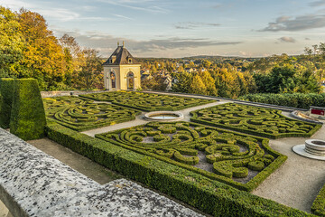 Small lovely public garden at the foot of 17th century Chateau d’Auvers sur Oise at sunset....