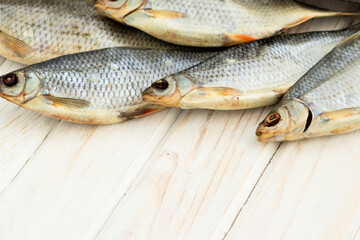 dry fish on a white wooden background with room for text.