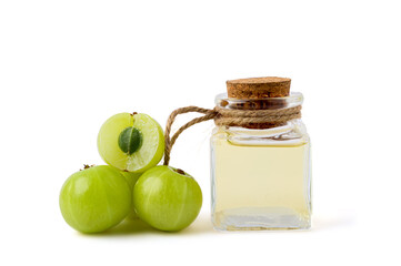 Essential oil extract From Amla in Transparent bottle With Amla cut Lay side isolated on white background