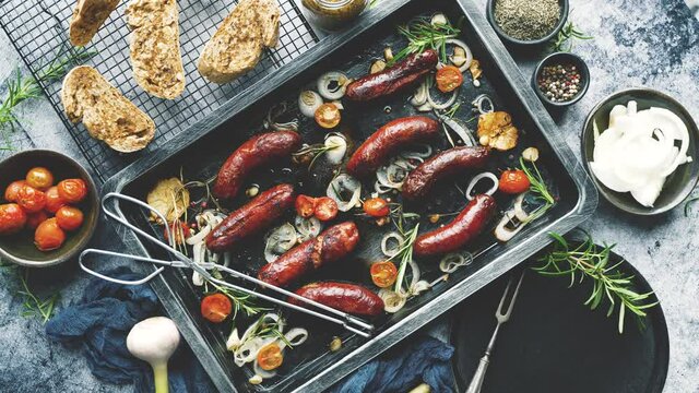 Delicious grilled sausages served on metal rusty tray. With barbecued vegetables