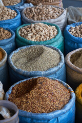Coriander seeds in a blue bag. Besides many other spices for example for Indian, Pakistani and Afghan cuisine. Day shot. 