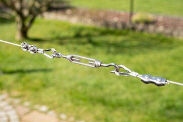 Turnbuckle to apply tension to a plant climbing aid made from stainless steel in the garden