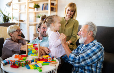 Senior grandparents playing with grandchildren and having fun with family