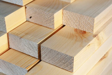 The wooden bars are stacked in a stack. Sawing drying and marketing of wood. Industrial background.