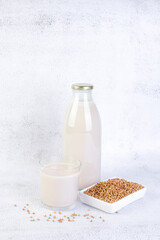 Buckwheat milk in glass bottle and glass.