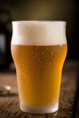 Glass of beer. Cold glass filled with beer.