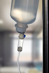 Closeup  of a saline IV drip Infusion bottle with IV solution for patients in hospital, selective...