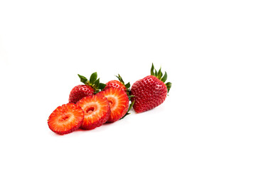 Whole and sliced ​​strawberries on a white background, early strawberries