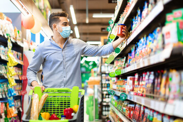 Arabic Guy Buying Food Doing Grocery Shopping In Modern Supermarket