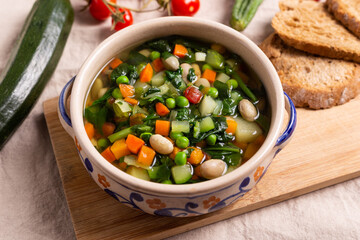 Mixed vegetable soup with bread. Minestrone, ideal for a light lunch or dinner