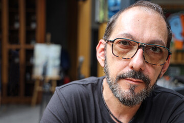 Closeup portrait of matured bearded man with eyeglasses.