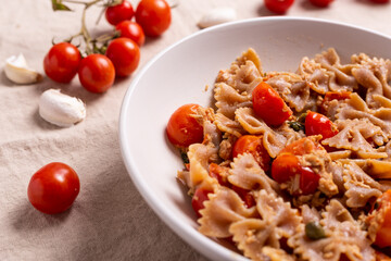 Pasta with tuna, cherry tomatoes and capers. Typical italian dish idea.