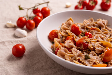 Pasta with tuna, cherry tomatoes and capers. Typical italian dish idea.