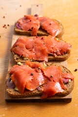 Salmon toast with avocado and red onions