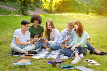 Pastime In Campus. Group Of College Friends Resting Outdoors After Classes