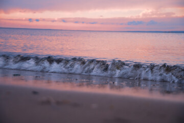 Pink sky and reflections in the surf on the ocean at sunset - Avalon, New Jersey.
