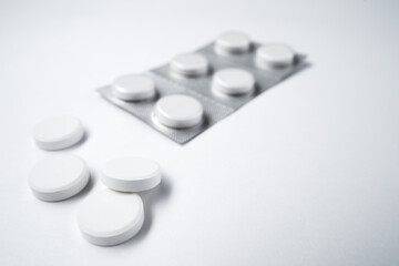 Pills on a white background. Coronavirus treatment, pandemic, quarantine. Isolated on white background, close-up, copy space.