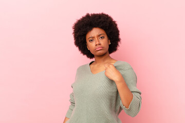 afro black woman looking arrogant, successful, positive and proud, pointing to self