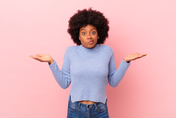 afro black woman feeling puzzled and confused, doubting, weighting or choosing different options...