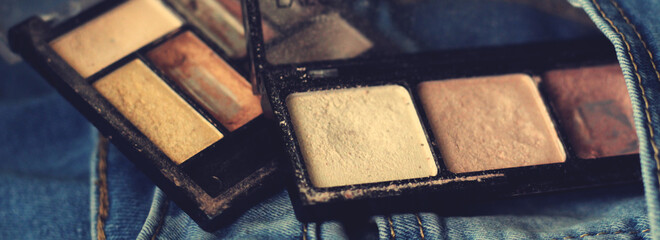 Brown eye shadow palette and jeans