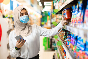 Muslim Lady With Smartphone Buying Food In Supermarket Groceries Store