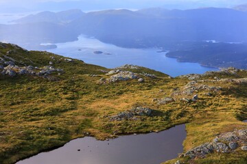 Fototapeta na wymiar Stord island landscape in Norway. Mountain view of Kattnakken. Tysnesoy island in background.