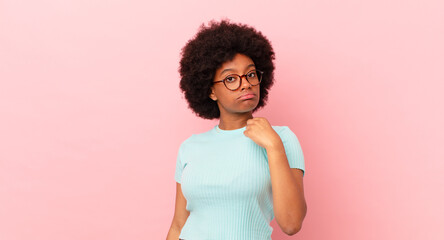 afro black woman looking arrogant, successful, positive and proud, pointing to self