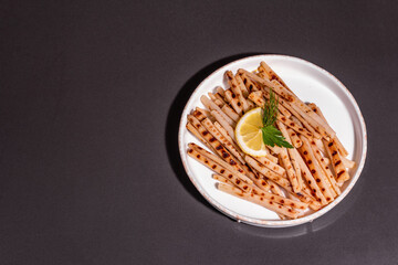 Grilled scorzonera with modern hard light, dark shadow