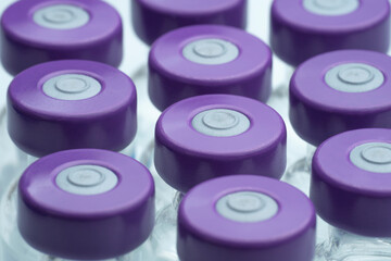 CLOSEUP AND TOP VIEW OF MANY COVID VACCINES VIALS. GLOBAL VACCINATION CAMPAIGN AGAINST CORONAVIRUS...