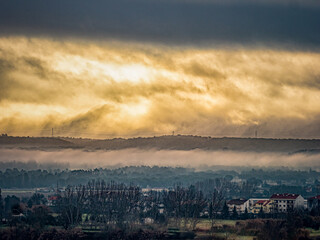 Naklejka premium The sun tries to break through the thick clouds