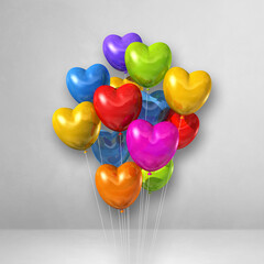Colorful heart shape balloons bunch on a white wall background