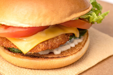 Hamburger close-up. Junk food from buns, tomatoes, lettuce and cutlets.