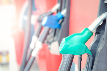 reen petrol pump filling nozzles at gas station, fuel gasoline dispenser