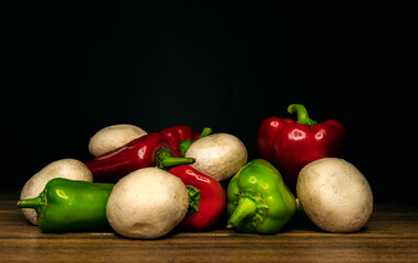 mushrooms, red pepper and green pepper on a black background