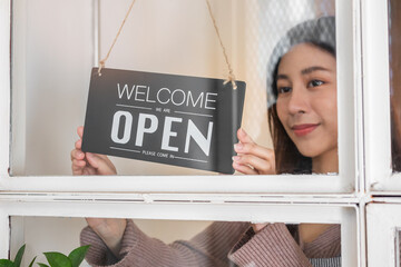 Smiling asian young business owner, employee retail,coffee shop woman,girl turning,setting sign...