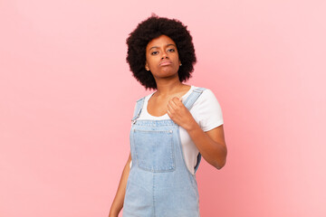 afro black woman looking arrogant, successful, positive and proud, pointing to self