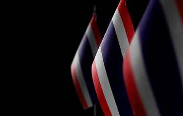 Small national flags of the Thailand on a black background