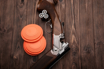 Clay target plates for shooting with rifle on wooden back
