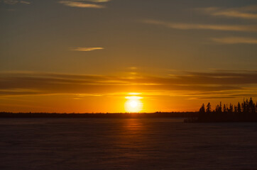Fototapeta na wymiar Sunset at a Frozen Astotin Lake, Elk Island National Park