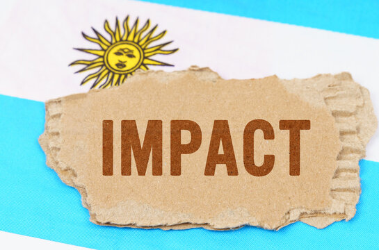 Against the background of the flag of Argentina lies cardboard with the inscription - impact