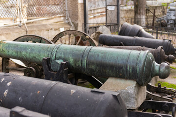 An old ship's cannon. Weapons on a pedestal at a historic building in Sevastopol.