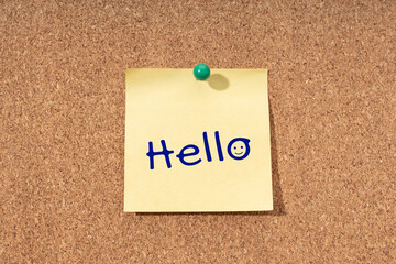 Hello word on yellow note on cork board
